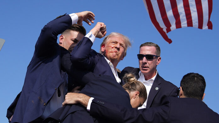 APTOPIX Election 2024 Trump Trump pumps his fist to assure crowd after being shot at rally